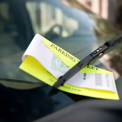 Parking ticket on dashboard of car