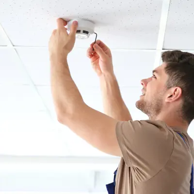 Man checking fire alarm